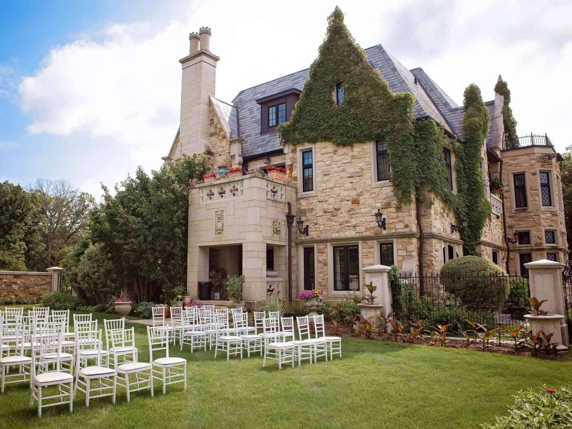 Large ivy-covered mansion venue with chairs arranged for wedding ceremony Washington