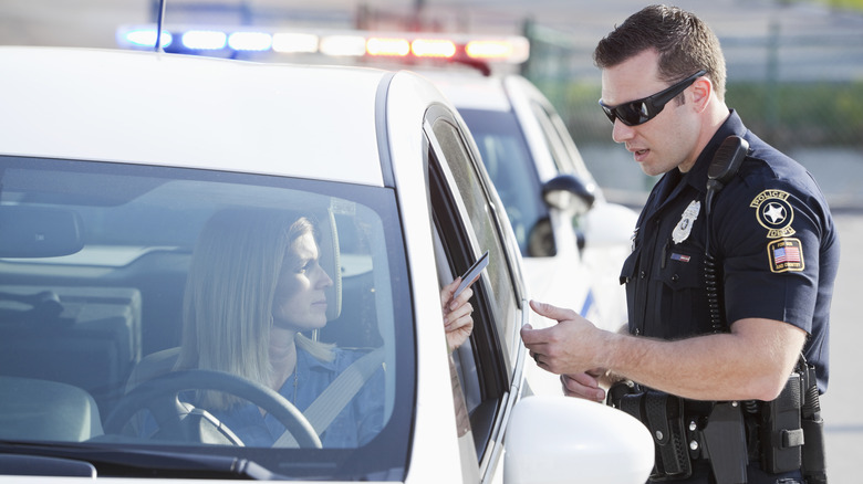 Woman (30s) driving car, pulled over by police (20s).