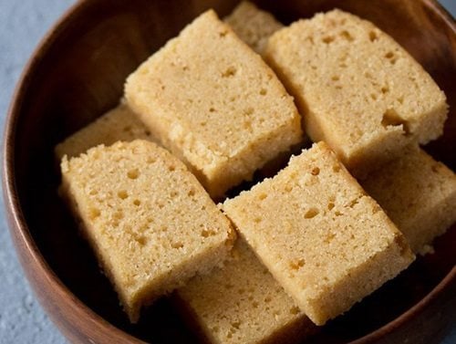 slices of atta cake kept neatly in a wooden bowl