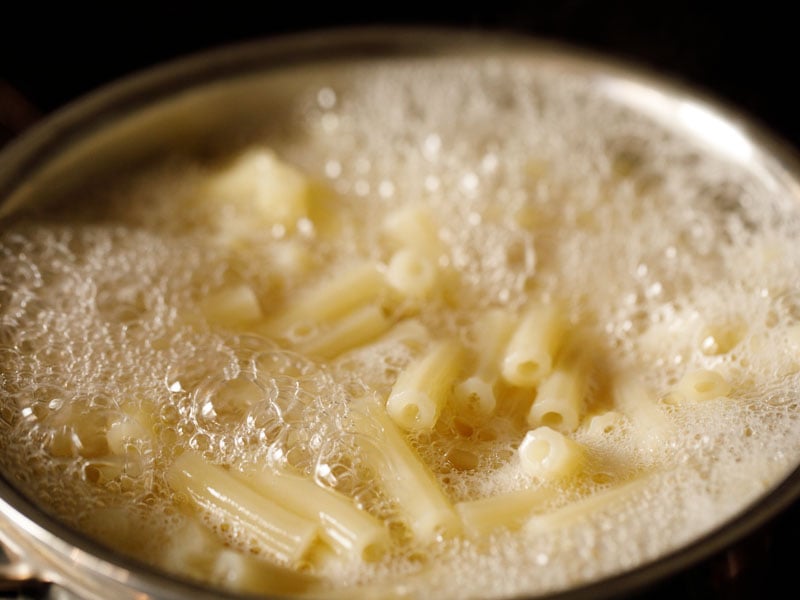 ziti rising to the surface of water in a pan after boiling