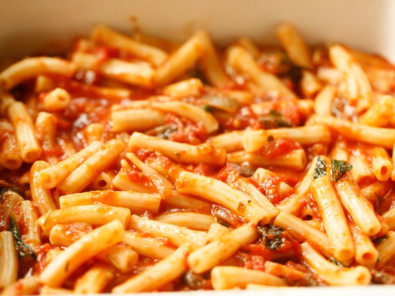 layer of tomato sauce tossed pasta in casserole