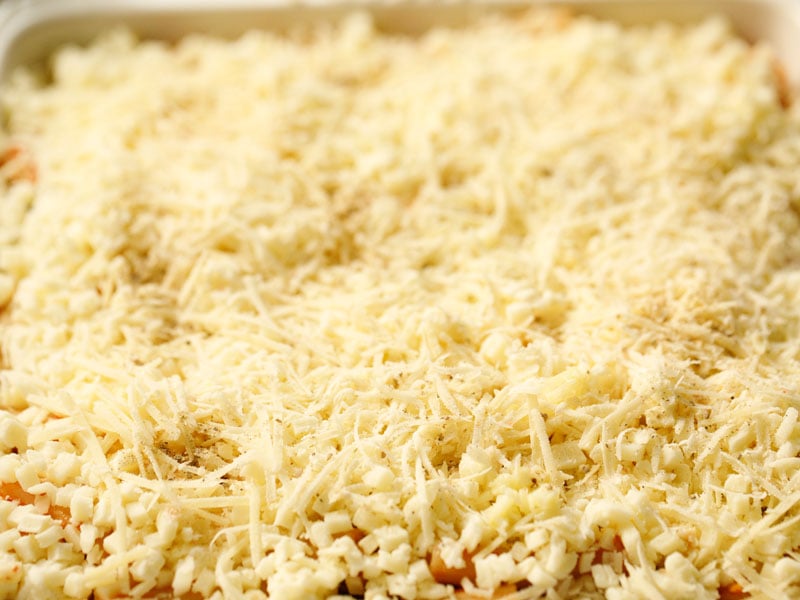 second layers of ricotta mix, mozzarella and parmesan cheeses for baked ziti casserole before going into the oven