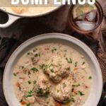 A bowl of chicken and dumplings in creamy sauce with vegetables, garnished with herbs, next to a glass of water and a casserole dish. Text reads "How to Make Chicken and Dumplings.