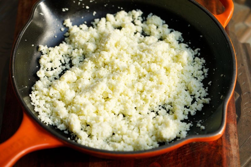 Sautéed grated mawa in skillet.