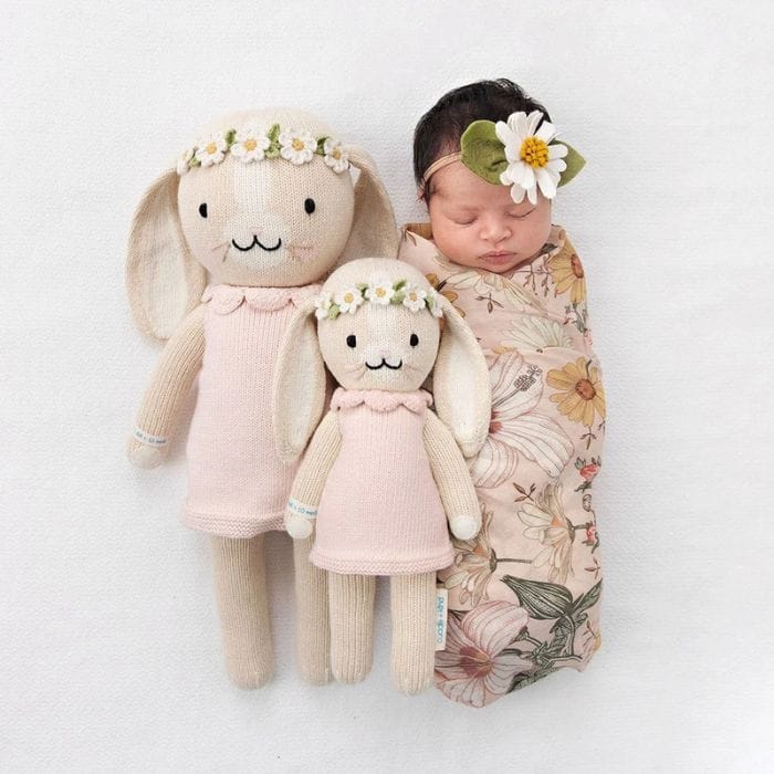 baby with cuddle + kind hand knitted chairty dolls