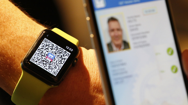 SALT LAKE, UT - AUGUST 04: A person scans a QR code on an Apple Watch to temporarily send their digital driver's license to another mobile phone at a Harmons Grocery store on August 4, 2021 in Salt Lake City, Utah. Utah is the first state in the nation to start to convert and offer digital driver licenses on mobile devices.