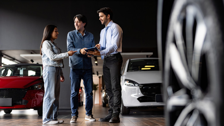 People at car dealership