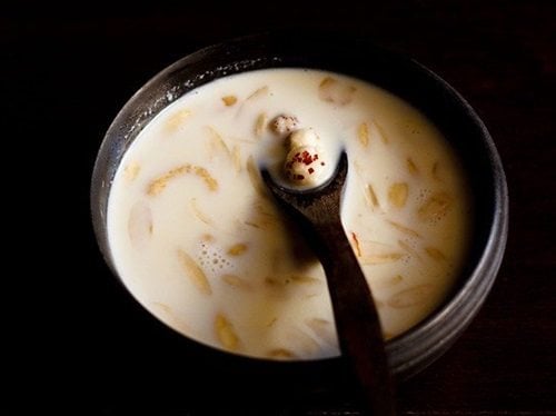 makhane ki kheer in a bowl with spoon inside.