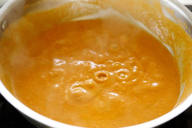 Paneer angara gravy simmering in pan.