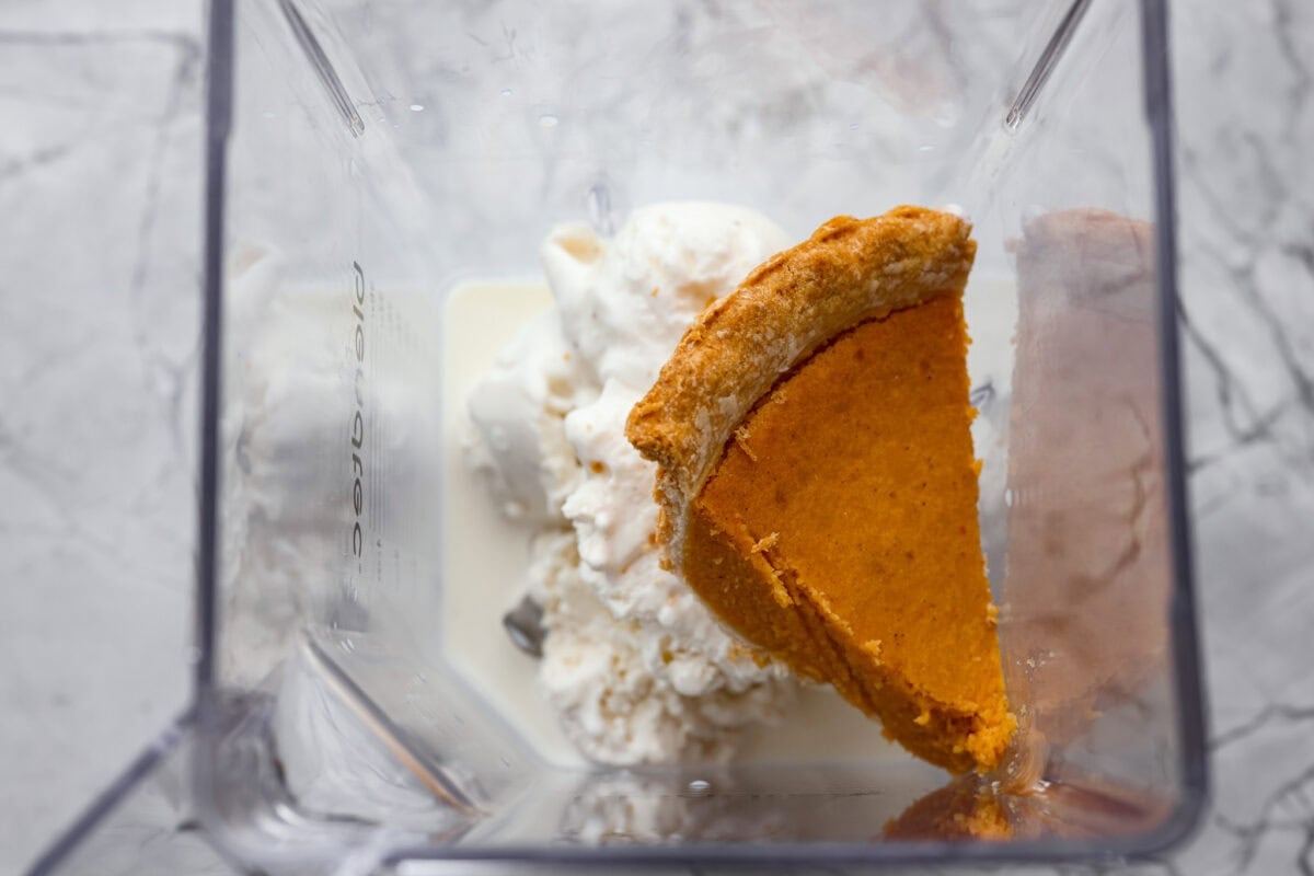 Slice of pie, milk, and ice cream added to a blender. 