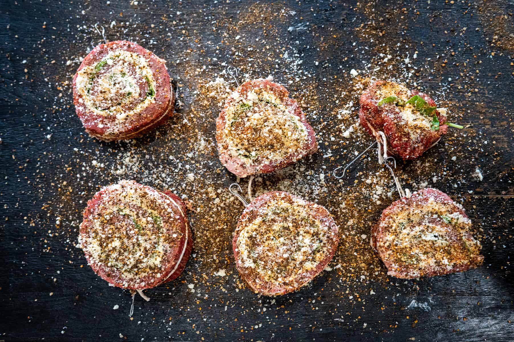 Slices of steak pinwheels seasoned.