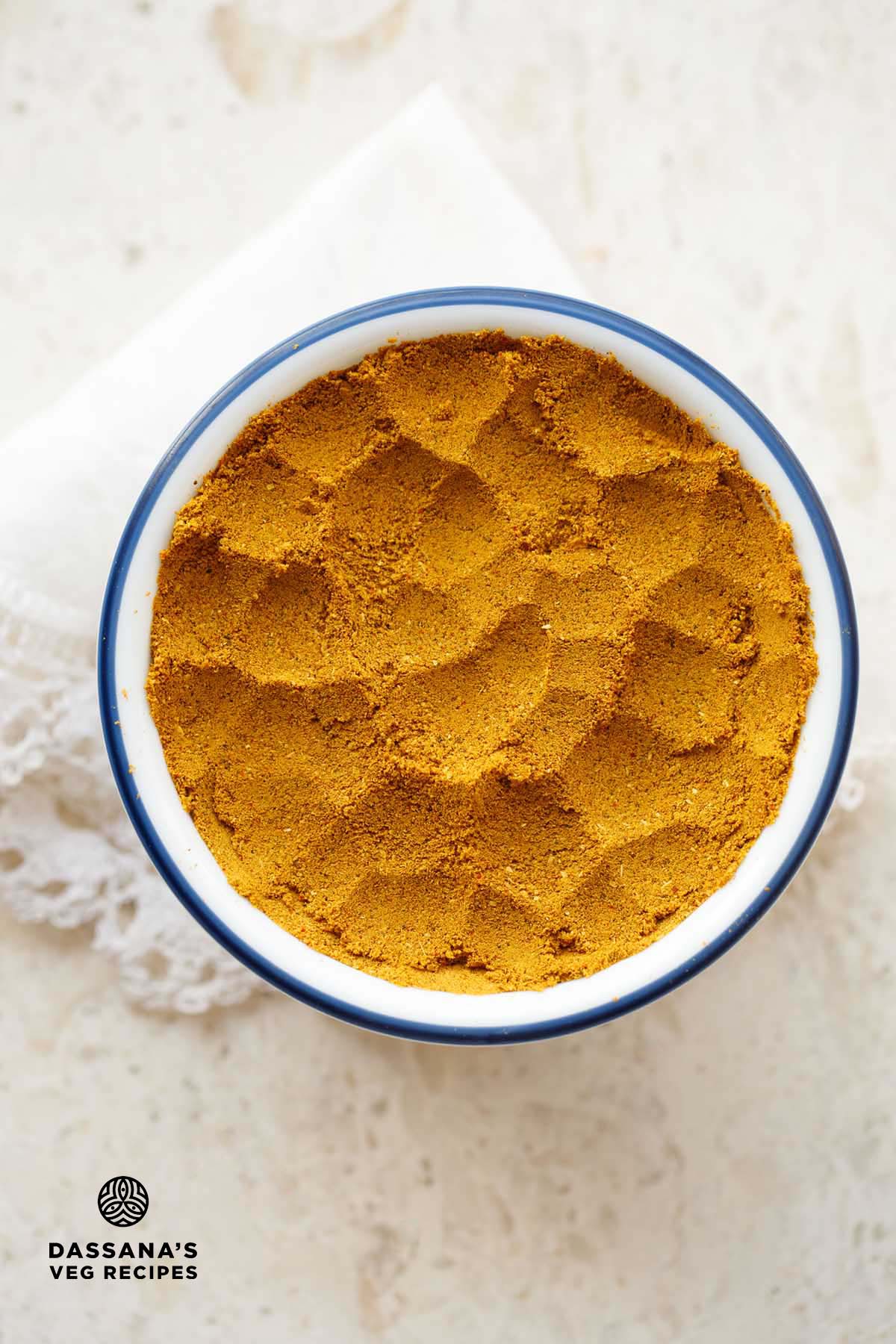 Bowl of vibrant yellow sabji masala.