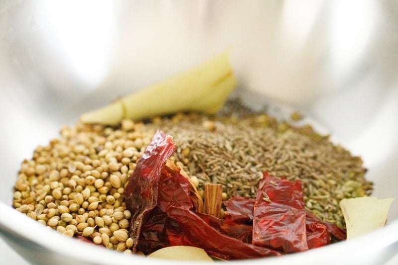 Assorted spices in a kadai.