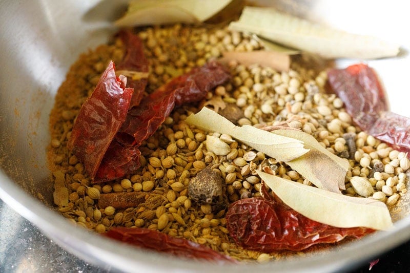 Spice mixture cooling in pan to make sabji masala.