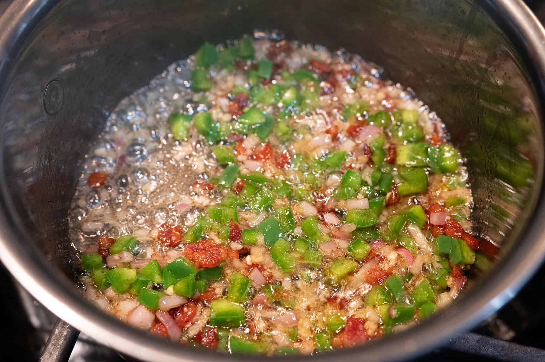 Vegetables cooking in butter and bacon.
