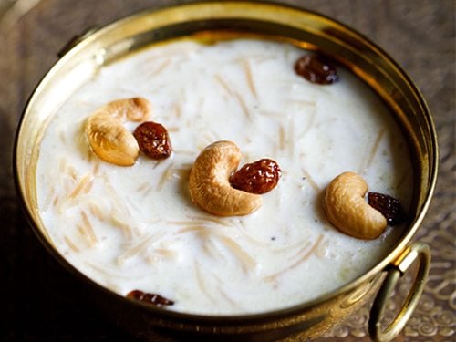semiya payasam garnished with cashews and raisins in a brass bowl