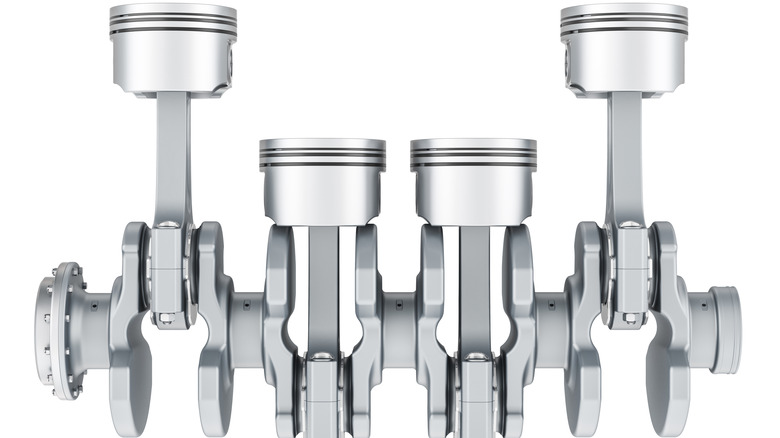 Four engine pistons attached to a crankshaft.