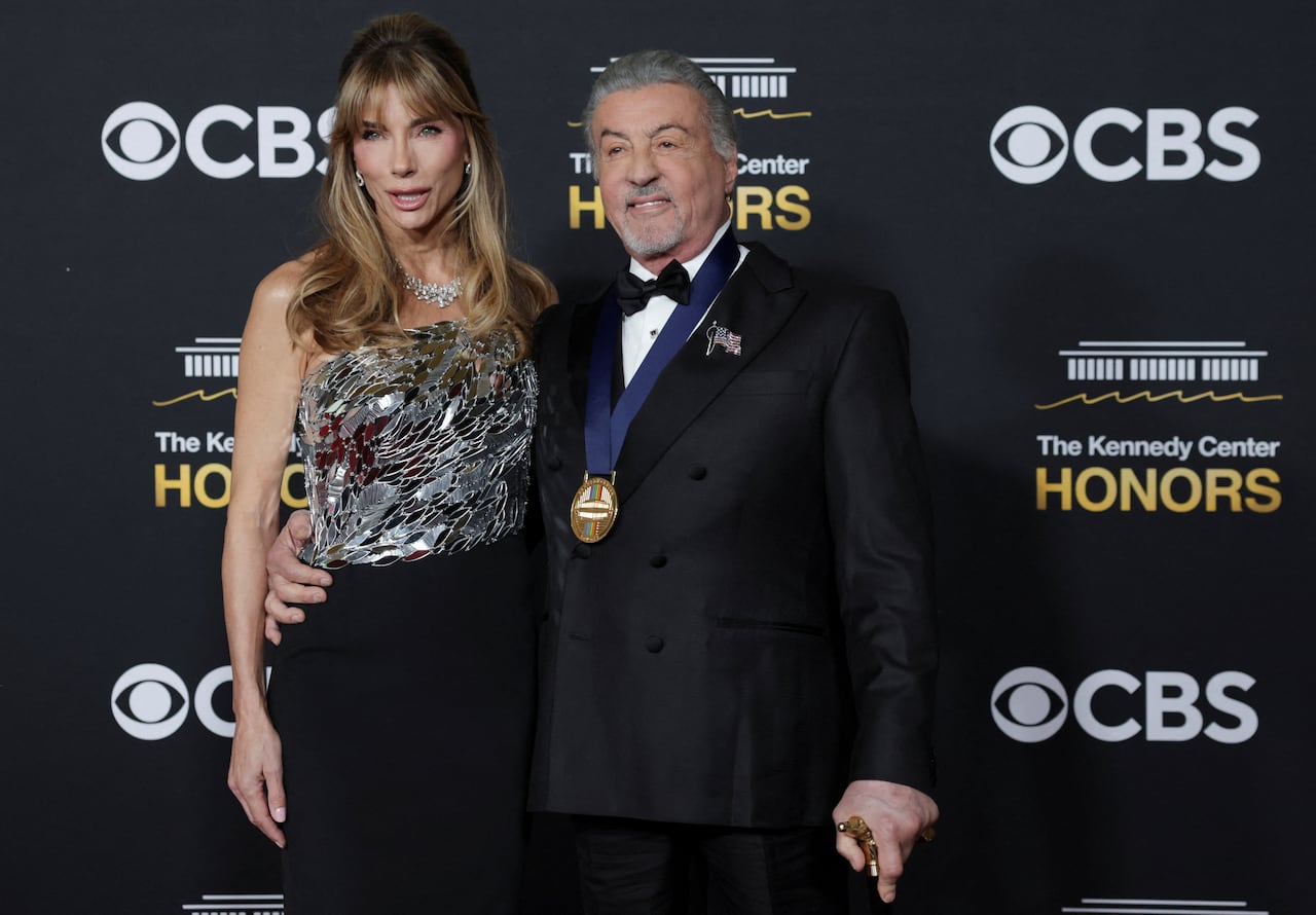 A couple poses for photos