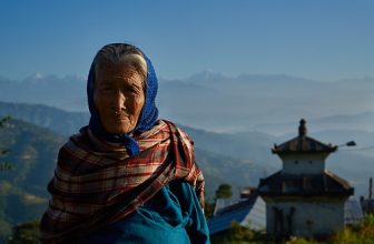 Newari old woman in front of Himalaya Range, Dulikhel, Katmandu Valley, Nepal