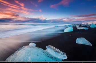 Iceland – Jökulsárlón Glacier Lagoon – Black Sand beach with Pieces of Ice at Sunrise