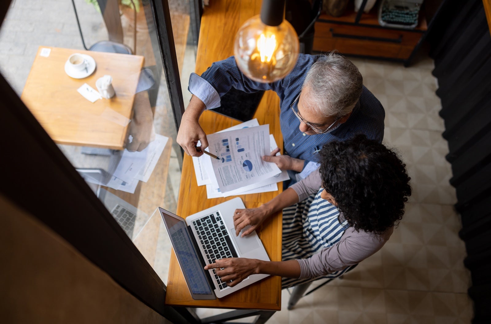 Business owner and manager working on the finances of the shop using a laptop