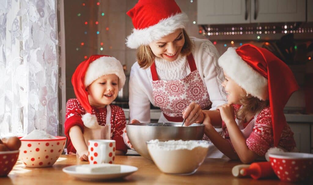 Christmas Eve traditions UK families love, baking treats together in festive Santa hats