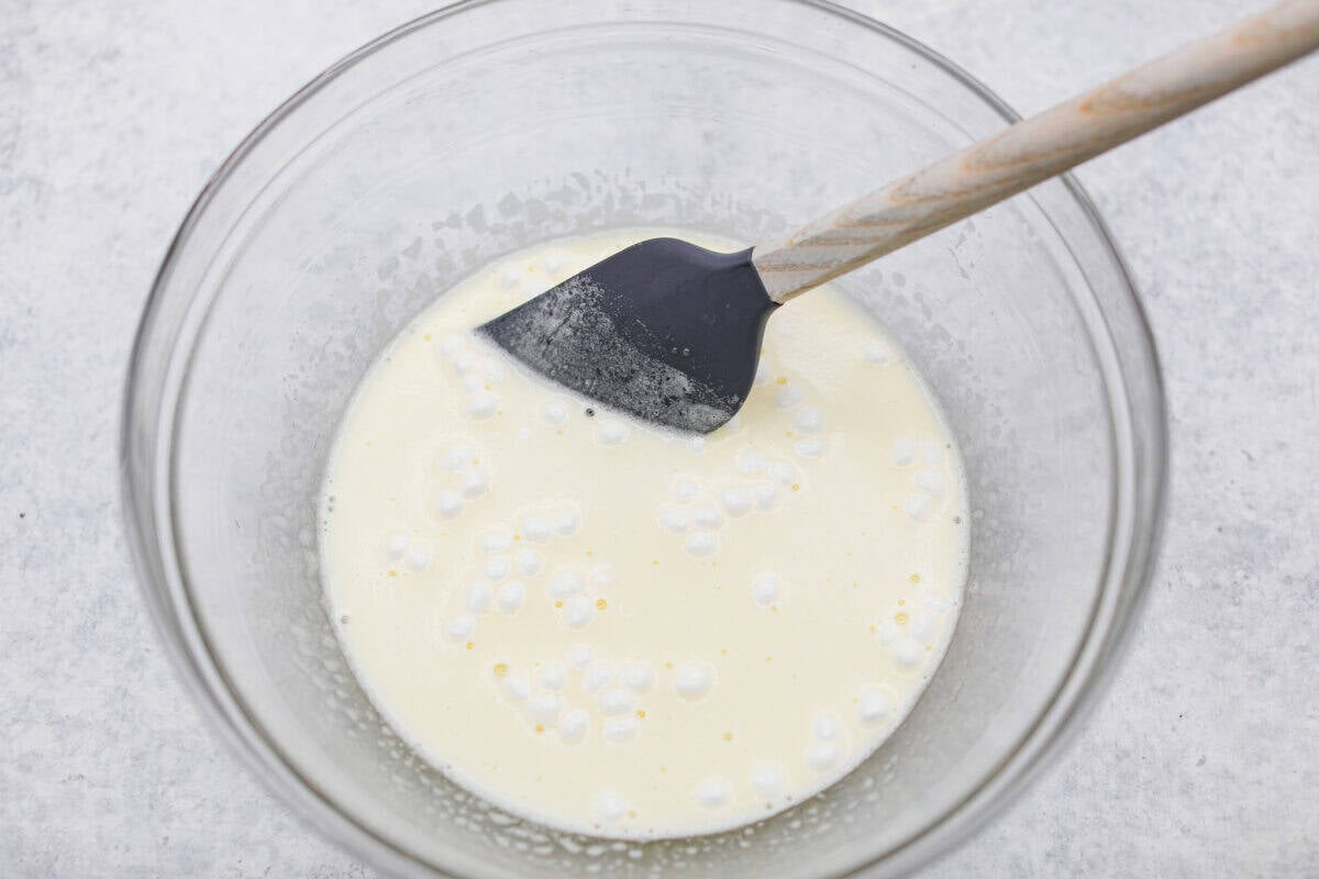 This Christmas ribbon salad brings all the festive vibes with its bright, sliceable layers. It looks fancy, but the process is super easy and mostly hands-off. Make it ahead and watch it disappear! Middle layer of lemon Jello and mini marshmallows mixed and dissolving in boiling water.