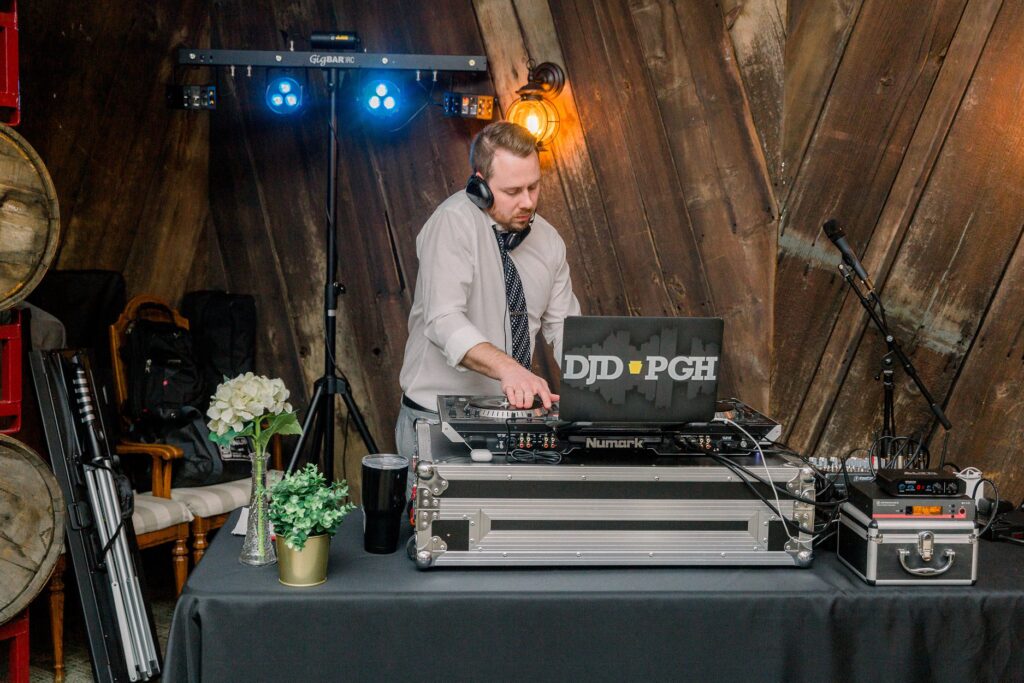 Matt Donnelly working as a DJ with his turntables and wearing headphones