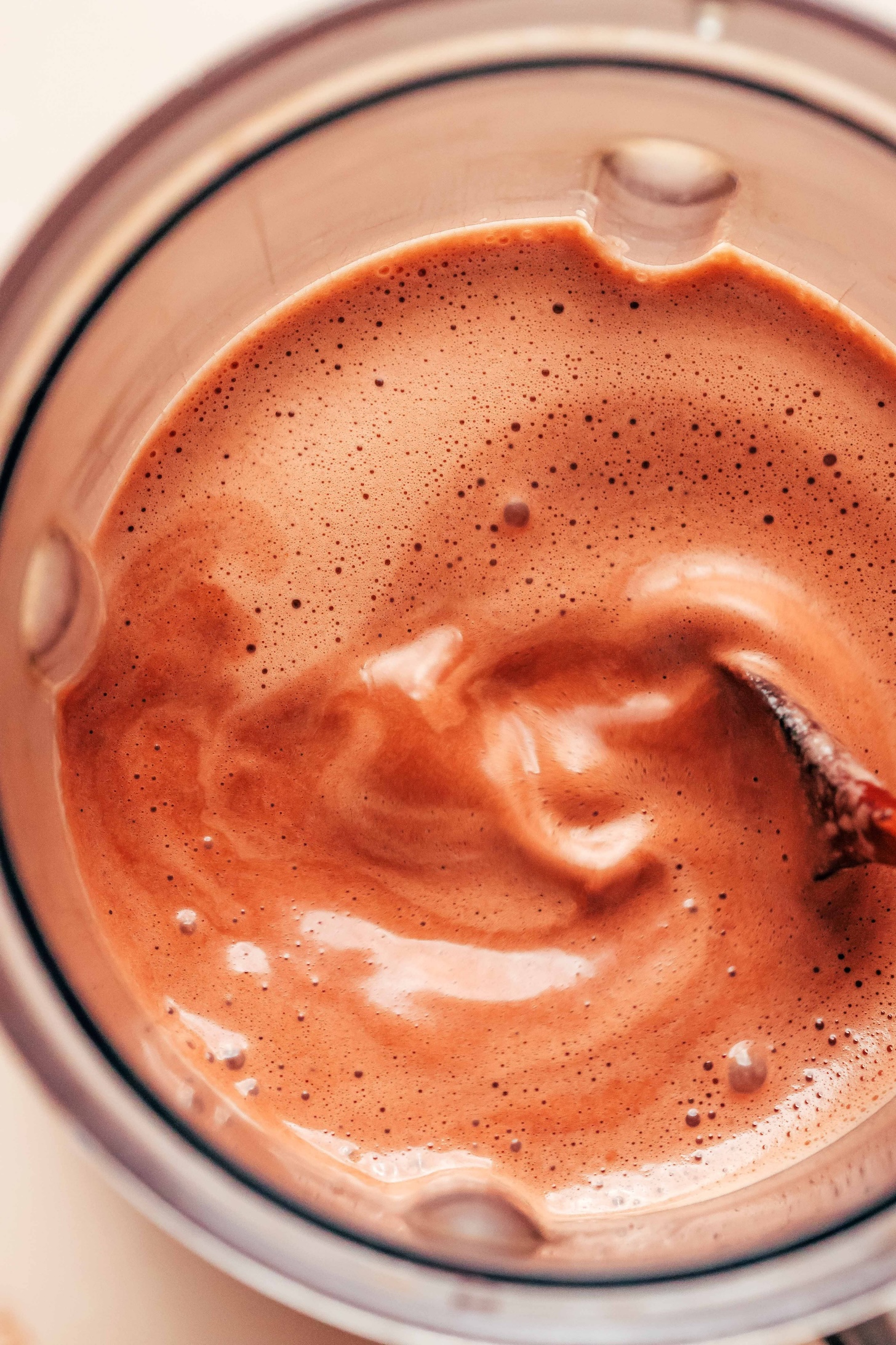 Blender with super creamy, frothy tahini hot chocolate