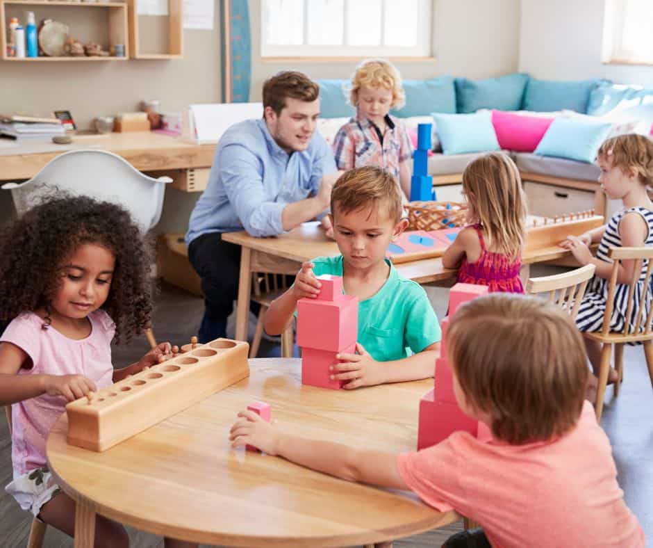 Teacher and students Working at Tables in Montessori School
