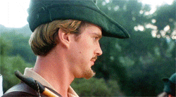 Cary Elwes turns his head and looks at the camera with a straight WTF face in Men in Tights