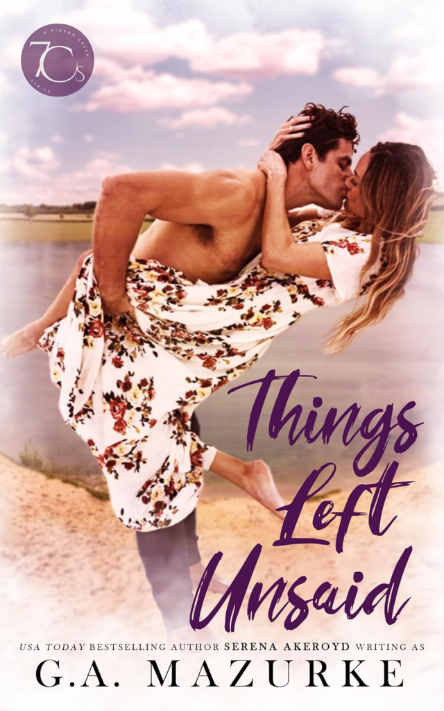 Things Left Unsaid by G.A. Mazurke. A shirtless man is lifting up and dipping a woman in a floral maxi dress. They appear to be on a rocky beach jetty.