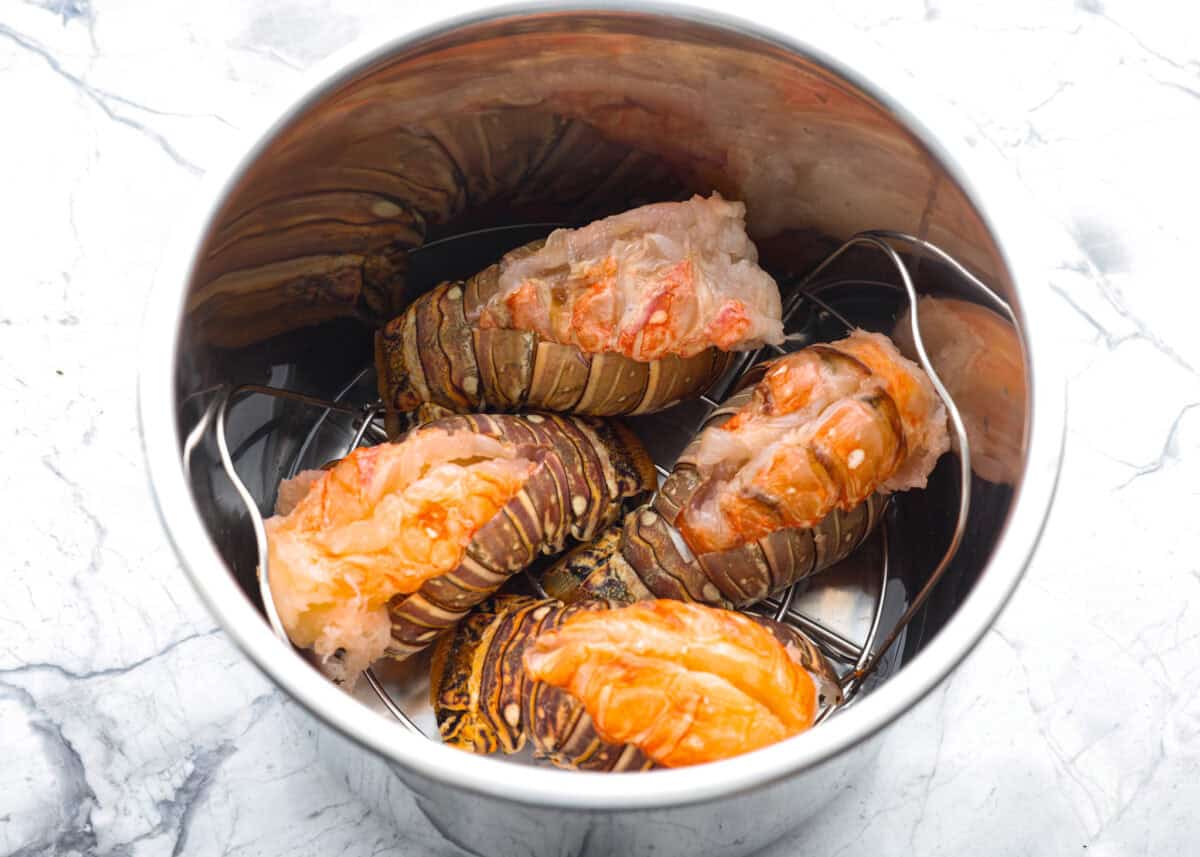 Instant pot lobster is the easiest way to bring a little luxury to your dinner table, no boiling pots or fancy techniques needed! In just minutes, the lobster cooks up tender, juicy, and perfectly steamed, ready to soak up a rich garlic herb butter. Lobsters tails added to the instant pot.