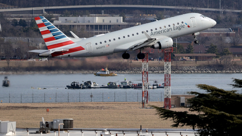 An American Eagle flight takes off from Reagan National Airport near where emergency crews work in the Potomac River on the crash site of an American Airlines plane on January 30, 2025 in Washington, DC.