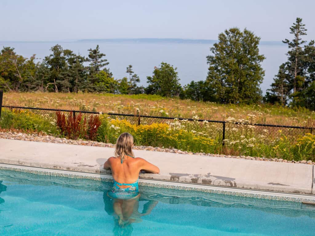 woman in warm pool overlooking bay of fundy at saltair spa