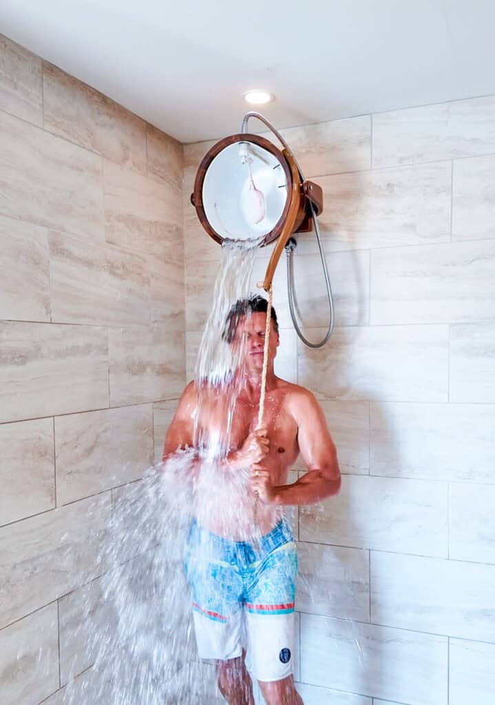 man under cold plunge bucket