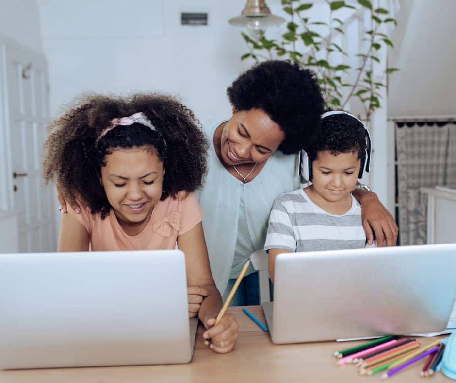 two young students being home schooled by their mother