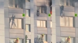 Woman jumps from burning apartment into fire brigade basket